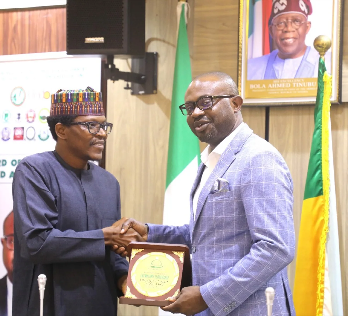 Receiving a leadership plaque, 2025